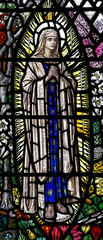 Stained glass window of Mary in a mandorla