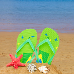 green sandals and starfish in sand