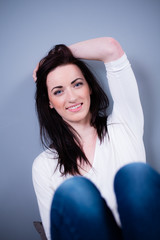 cheerful young caucasian woman with black hair blue eyes