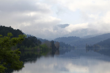 Fototapeta na wymiar Foggy landscape with water reflection