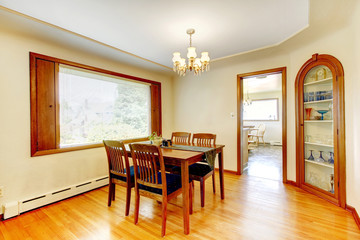 Soft tones dining room with wooden furniture