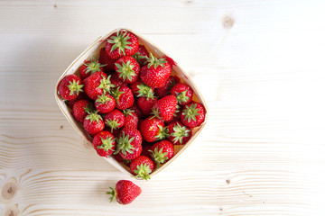 many strawberries in a wooden basket