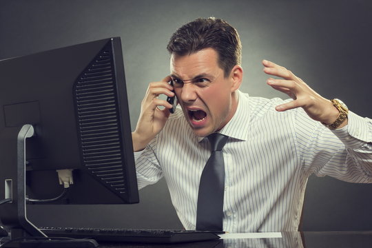 Angry businessman shouting on phone