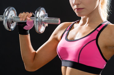 Fototapeta na wymiar close up of sporty woman with heavy steel dumbbell