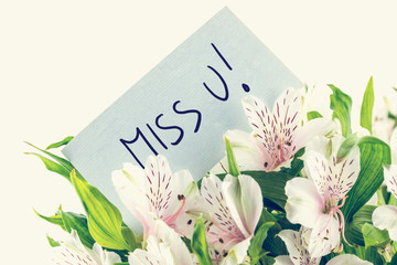 Bunch of white tiger lillies with a Miss u card - obrazy, fototapety, plakaty