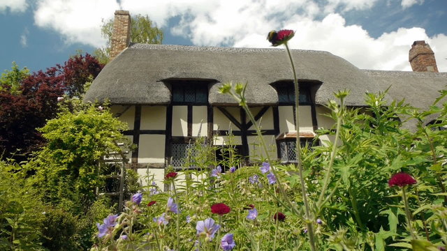 Medieval half-timbered English cottage seen from the garden.