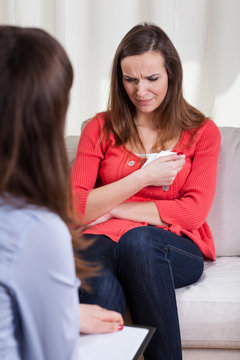 Woman crying at psychotherapy