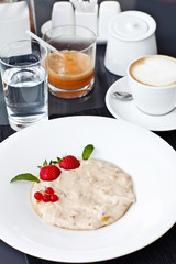 Semolina porridge in a plate with fresh strawberries. Health Bre