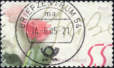 stamp shows rose as a gift with the inscription  Regards