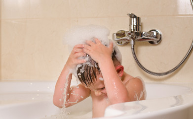 Boy with bubbles on his head