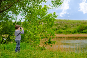 Small girl looking through binoculars