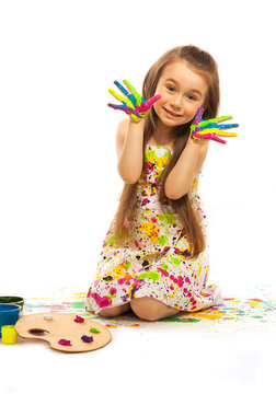 Little girl with hands painted in colorful paint