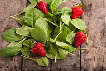 fresh baby spinach and strawberries