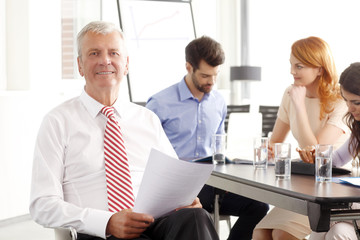 Senior businessman sitting at meeting