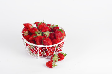 fresh strawberries in a basket on a white background