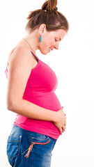 Pregnant woman in profile shows her belly on white background