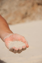 sand flows through the female hands