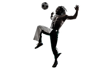 black man soccer player juggling football silhouette