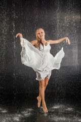 Fototapeta na wymiar Blonde girl in dress in water studio