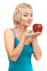 blond woman holding red apple.