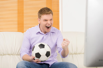 excited mature man watching football.