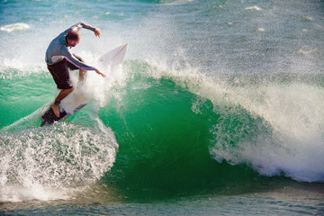 Surfer on Blue Ocean Wave in Bali