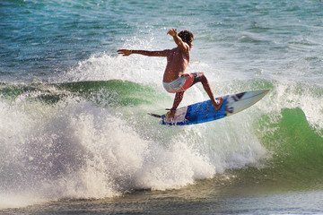 Surfer on Blue Ocean Wave in Bali