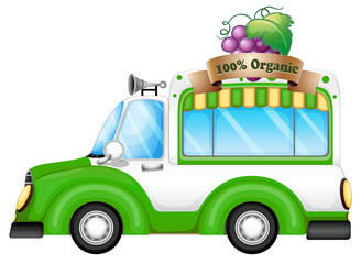 A green vehicle selling organic fruits