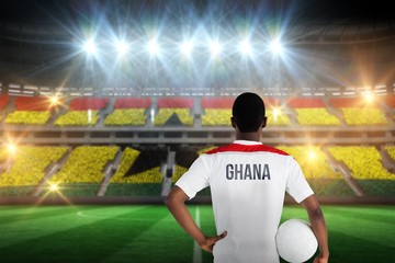 Composite image of ghana football player holding ball