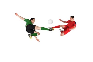 Fototapeta na wymiar Football players tackling for the ball
