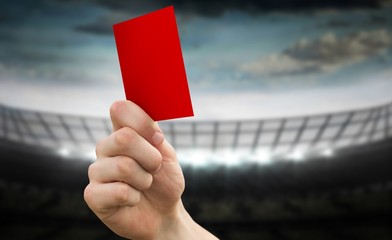 Composite image of hand holding up red card
