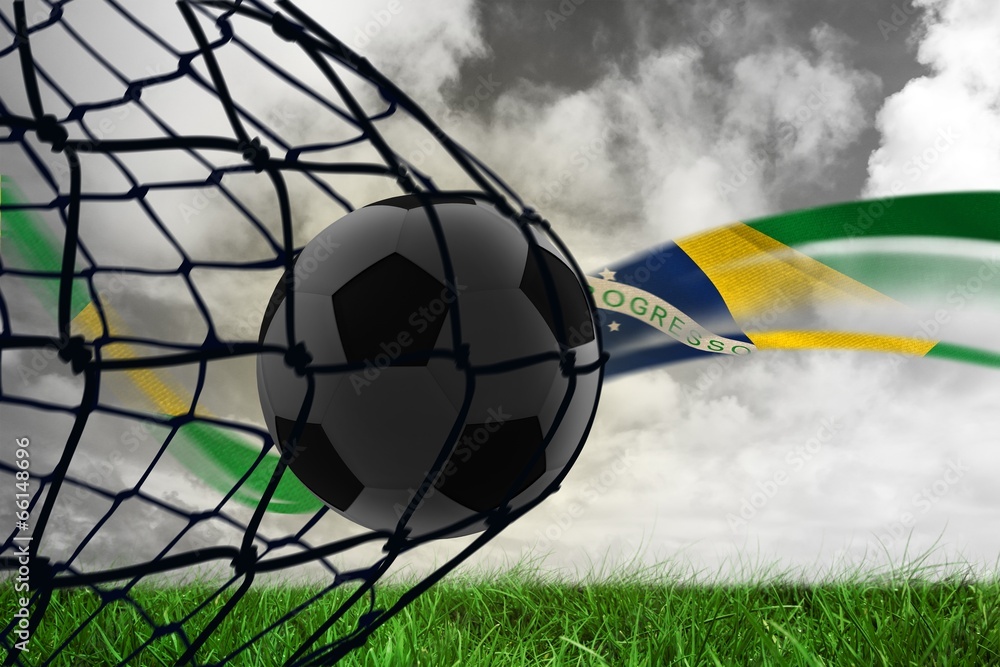 Aufkleber Composite image of football in back of the net