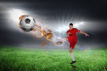 Obraz na płótnie Canvas Composite image of football player in red kicking