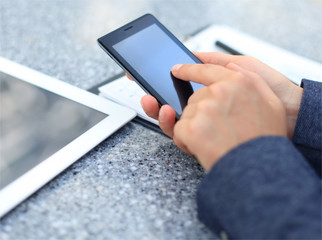 Close up of a business woman using mobile smart phone