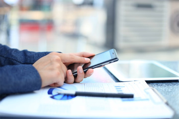 Close up of a business woman using mobile smart phone