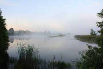 Obraz premium Foggy landscape with a lake.