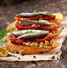 Crostini with anchovies, olives and sun-dried tomatoes