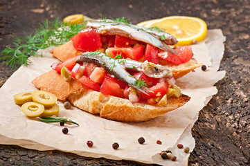 Crostini with anchovies, olives and tomatoes