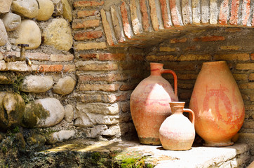 Old clay jugs in the brick and stone place