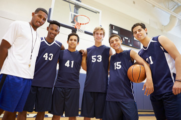 Members Of Male High School Basketball Team With Coach