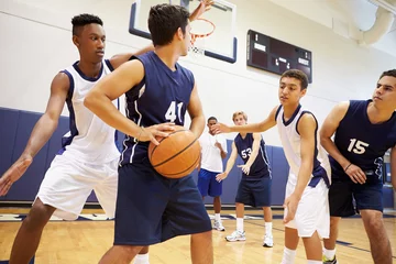 Fotobehang Male High School Basketball Team Playing Game © Monkey Business