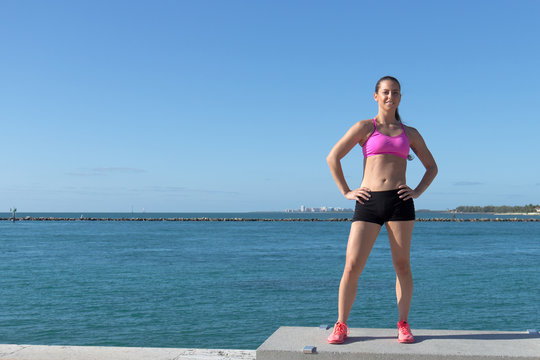 Determined, fit hispanic woman by the ocean