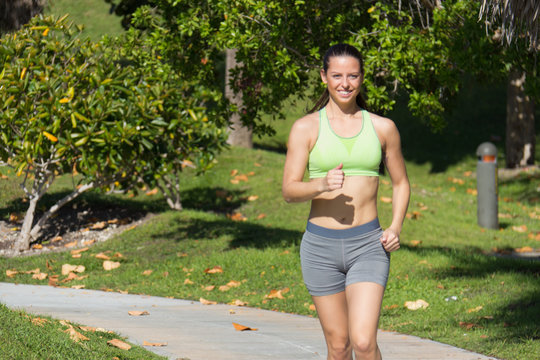 Hispanic woman jogging on a path