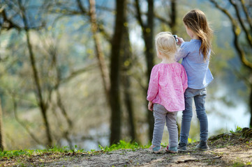 Fototapeta premium Two sisters taking a photo with a smartphone