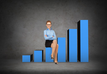 Fototapeta premium smiling businesswoman in glasses sitting on chart