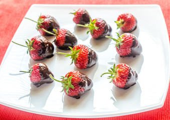 Fresh strawberries covered with dark chocolate
