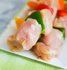 raw chicken kebabs with baked potatoes