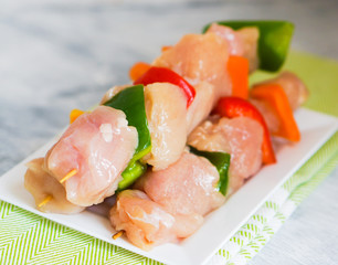 raw chicken kebabs with baked potatoes