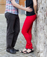 Happy young couple in love at the stone wall