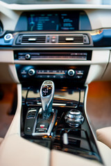 automatic gear shifter in a new car. Car interior details